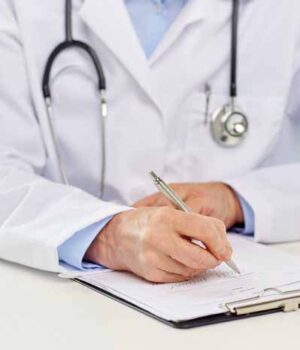 senior-doctor-with-clipboard-writing-at-hospital-pzhjx98-min Мешканцям Нововолинська